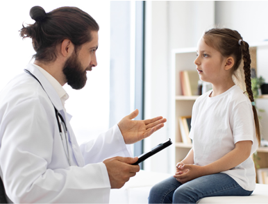 male doctor talking with a young girl at a health checkup