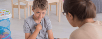 young boy talking with a mental health provider